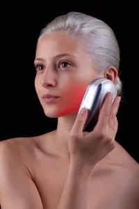 woman using red light therapy for skin rejuvenation